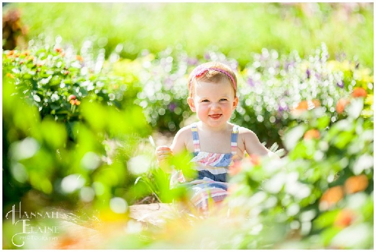 little girl hidden among the flower garden