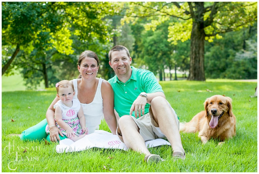 the pup joins the family for a photo in the park