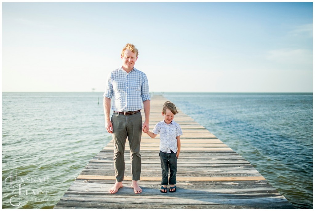 dad and son on the dock in mobile bay