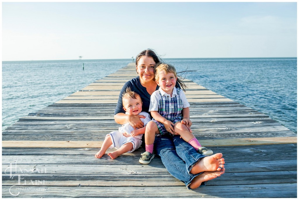 mom and sons on the beach overlooking mobile bay dockside