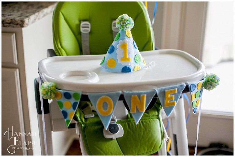 high chair decorated for little boy's first birthday party