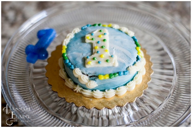 blue one year old birthday smash cake with blue candle