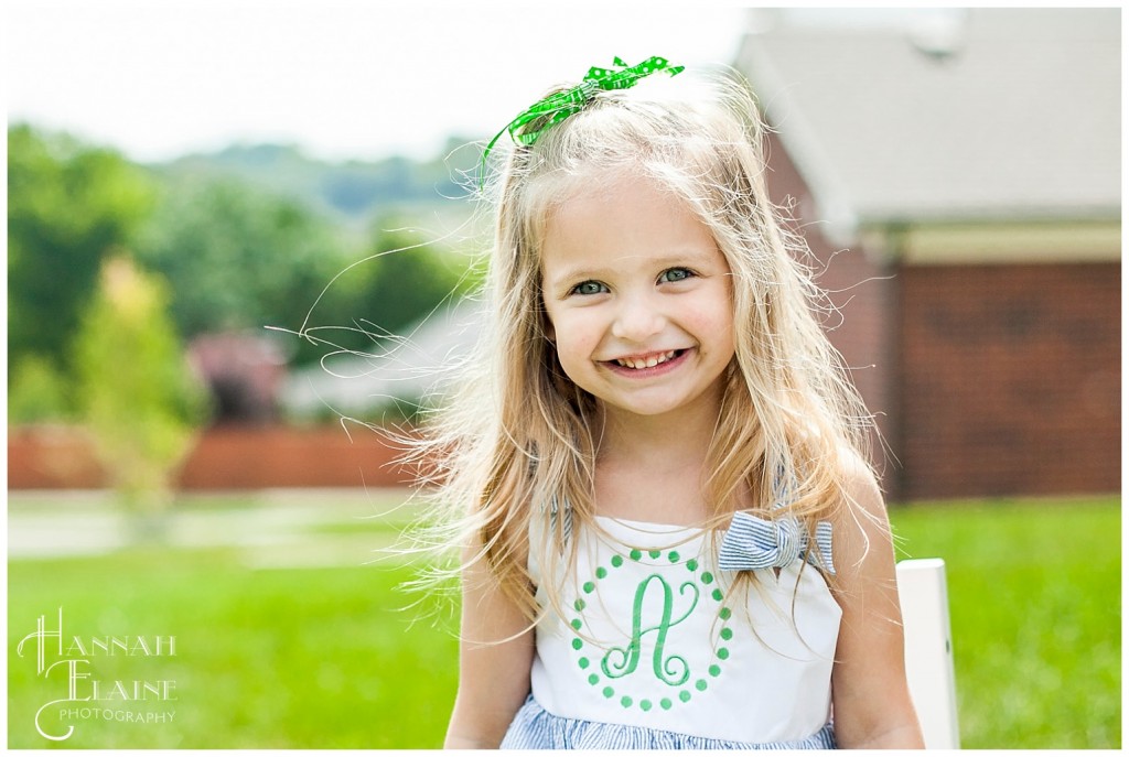 beautiful blond amelia smiles in her A monogramed dress