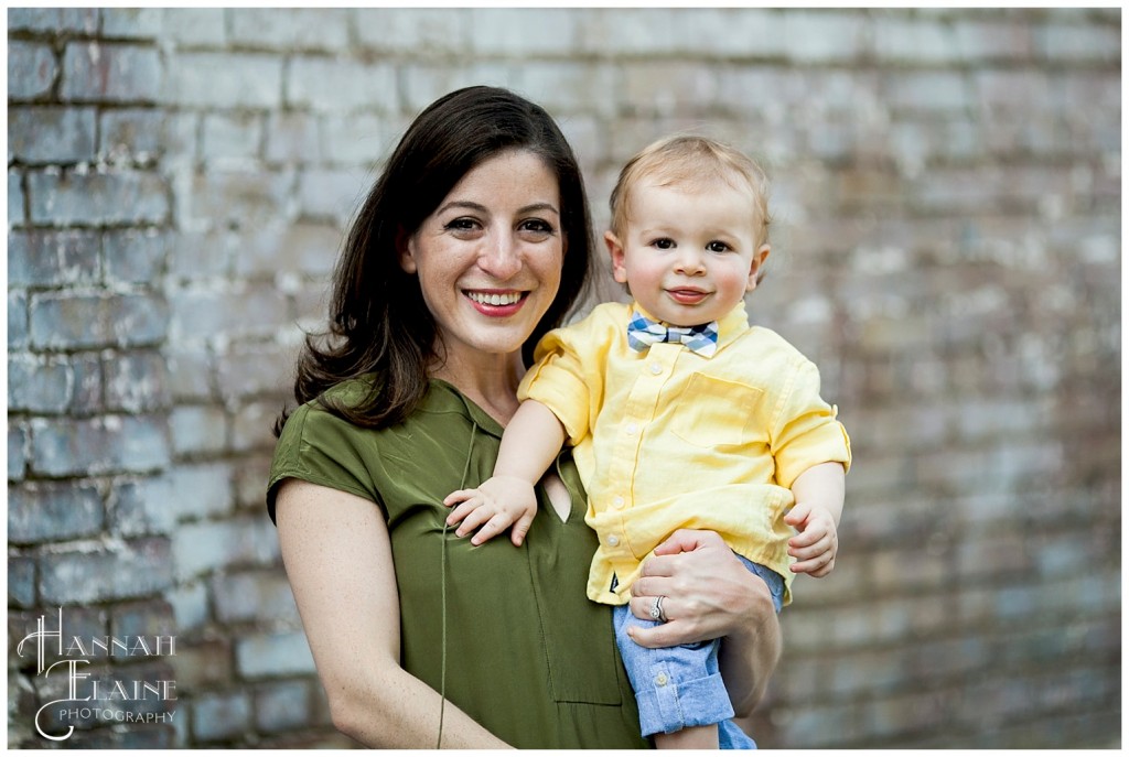 mom holds her little bow tied boy