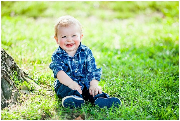 little boy in blue plaid laughs at daddy's jokes