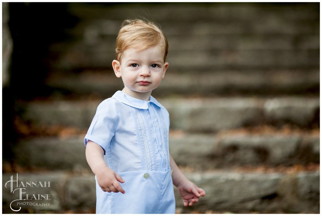 toddler hangs on the steps at percy warner park