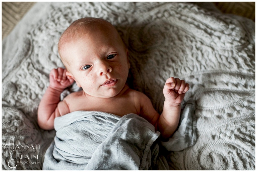 baby in blue blanket wrapped up