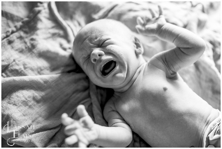 black and white image of baby crying
