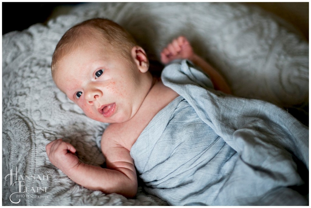 baby wrapped in blue cheesecloth