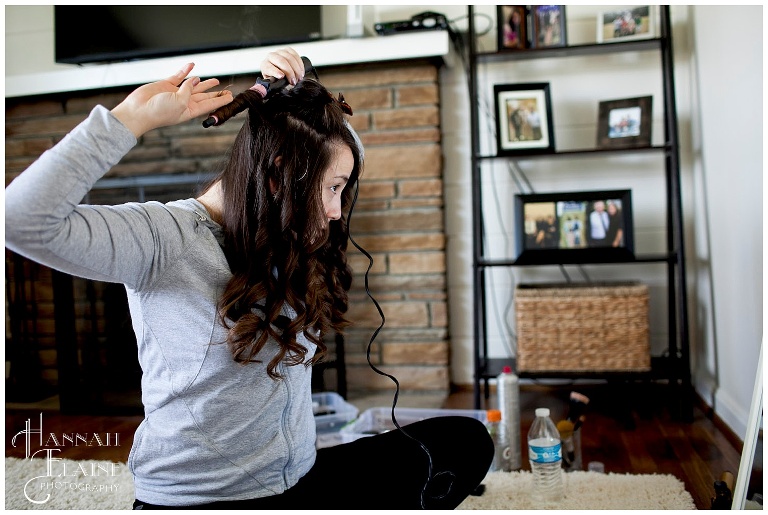 bride curls hair in the living room