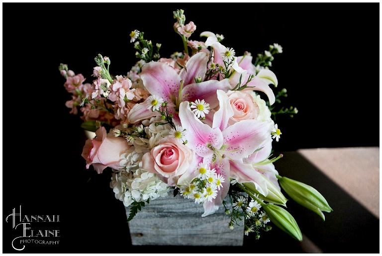a box of lilies and roses in pink spring colors