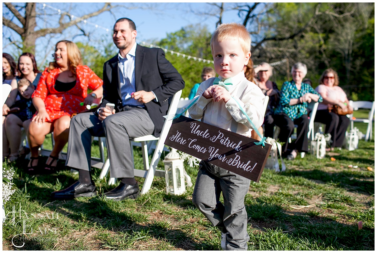 here comes the bride sign held by ring bearer