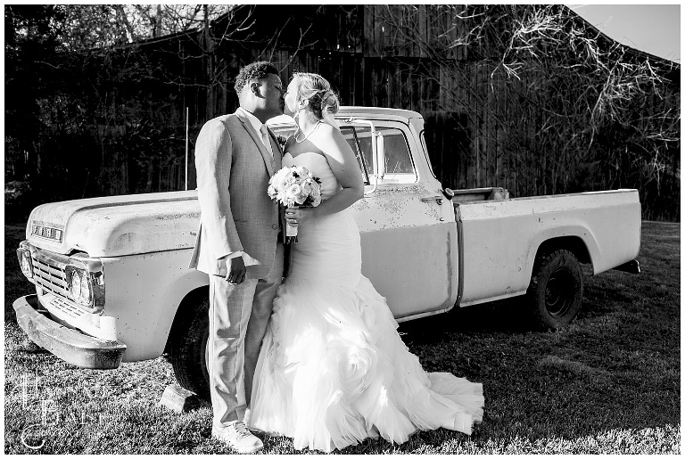black and white image bride and groom in front of vintage ford