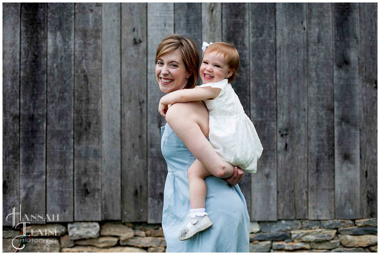 mom holds daughter on her back