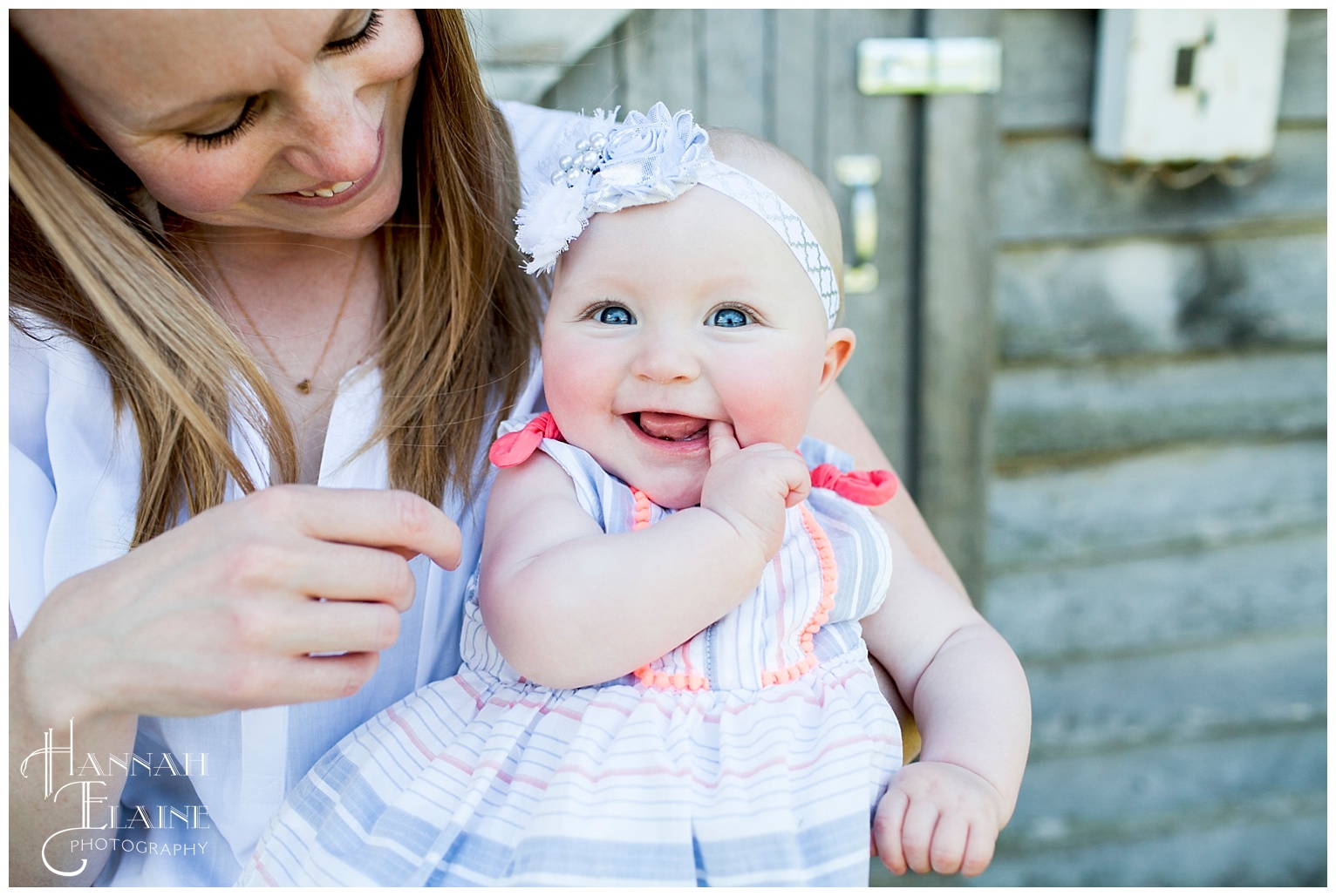 olivia and mom in front of rustic barn at gravel road traditions