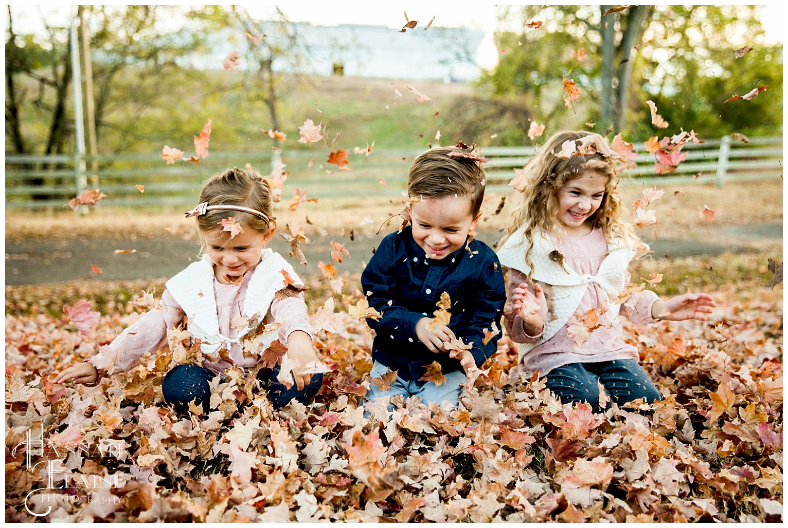 kids play in the leaves at ellington agricultural center