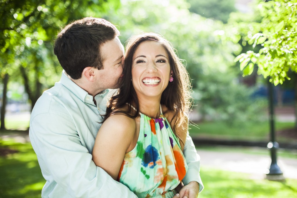 a couple laughs at a secret whispered in huntsville alabama engagement session