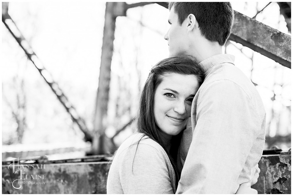 rustic train trellis serves as background for engagement photos