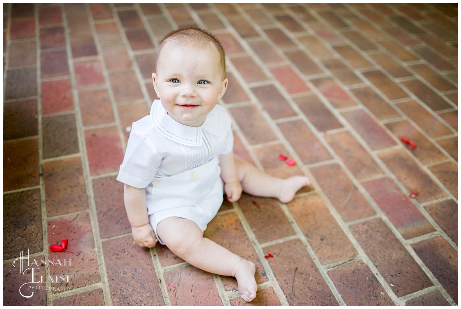 6 month picture on a brick pathway